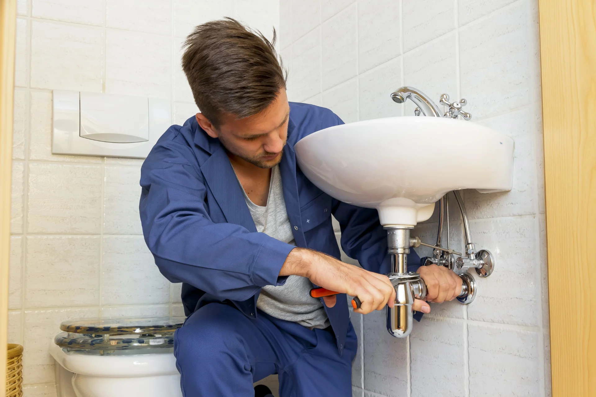 Drain cleaning technician working in Bradford home
